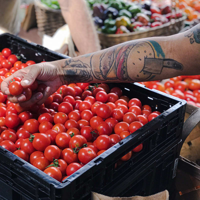 Market produce with tattooed arm